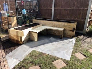 Outdoor seating area created within garden